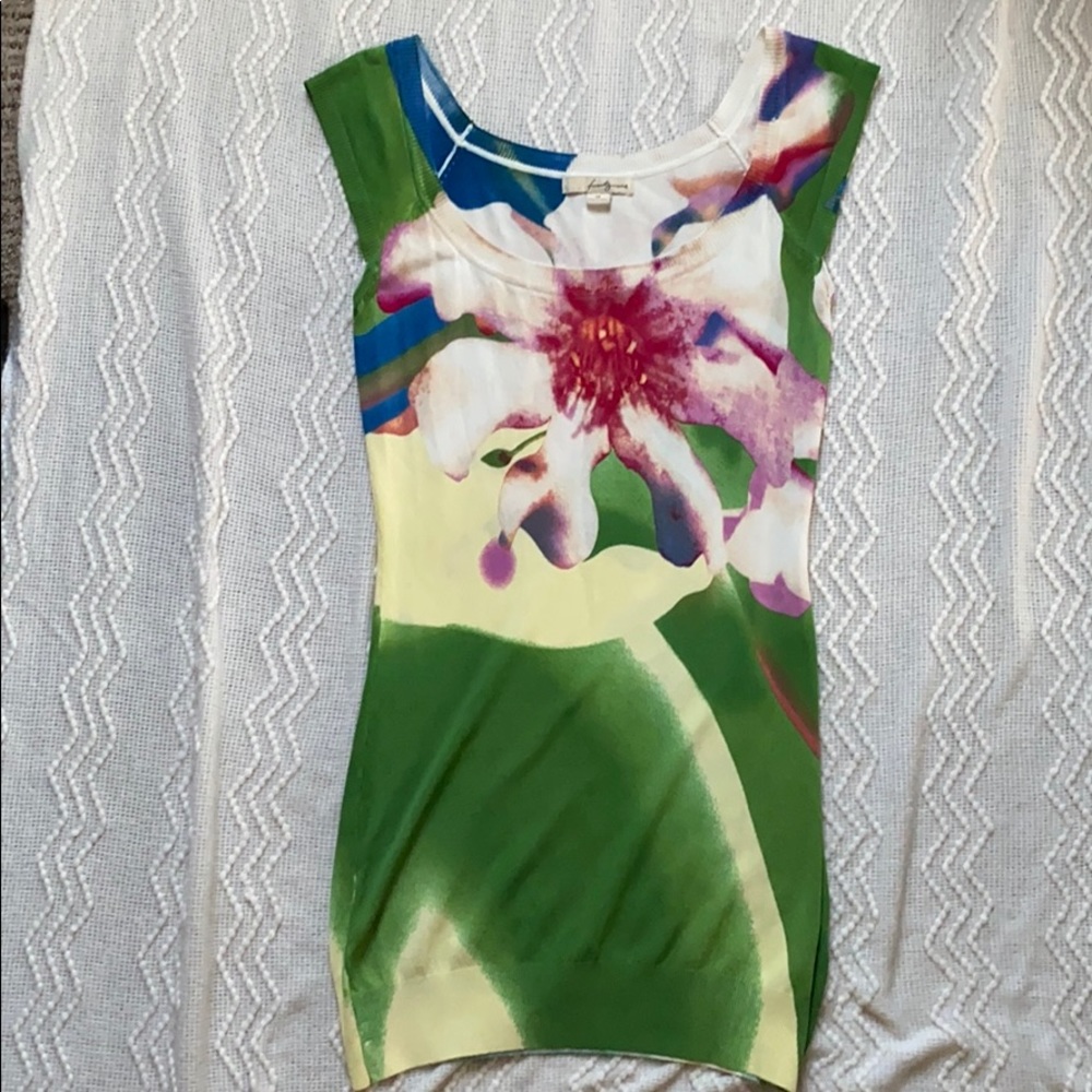 Green fitted dress with floral design.